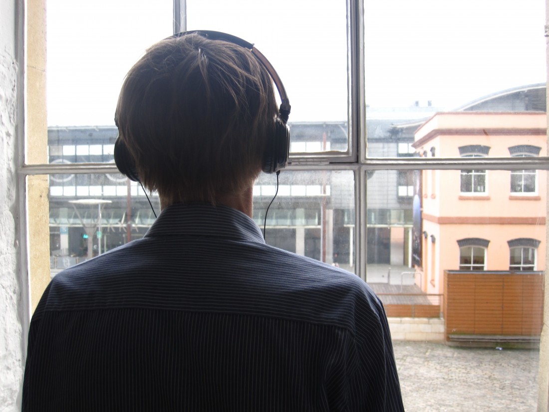 Proto-Type HeadphoneImage Proto-Type Theater: Fortnight. The back of a man wearing headphones.